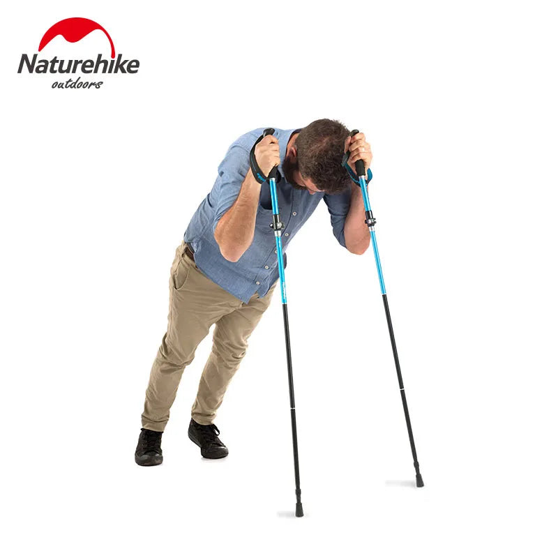 Man leaning forward on a pair of trekking poles