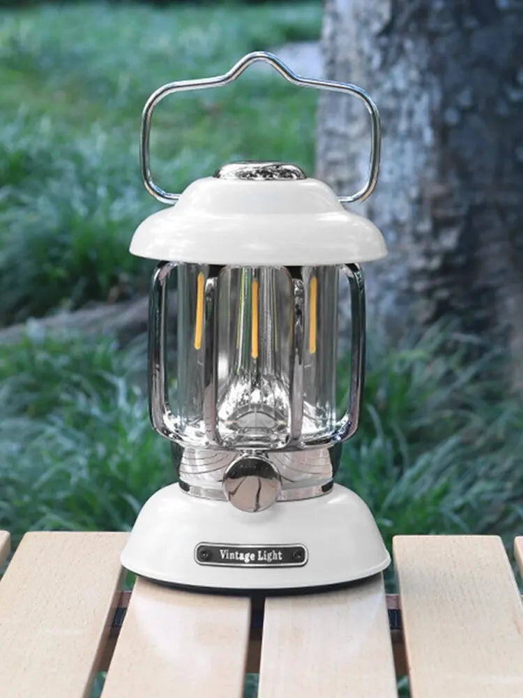 White retro LED camping lantern on a wooden table