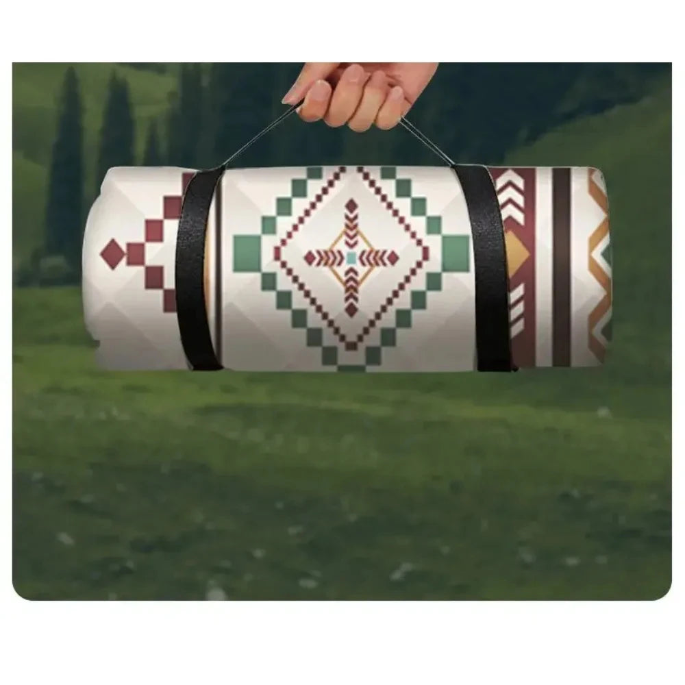 Rolled picnic blanket carried by its strap