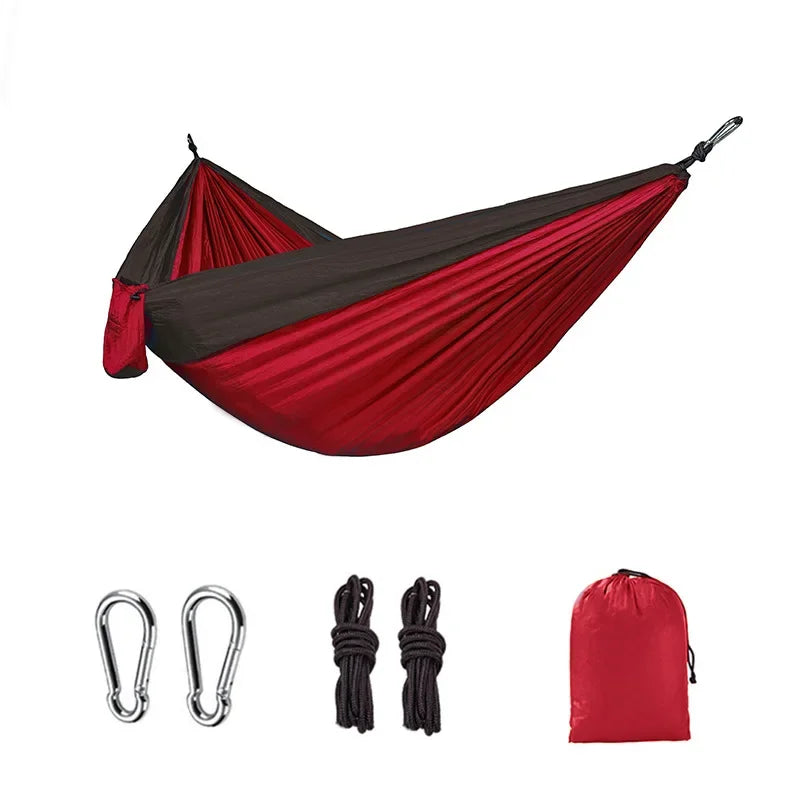 Red and brown camping hammock with carabiners, ropes and storage bag