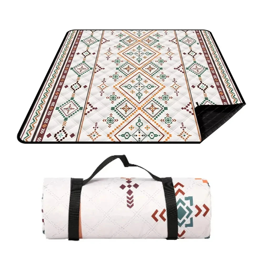 Picnic blanket unfolded to show the black backing, and rolled up with its carry strap