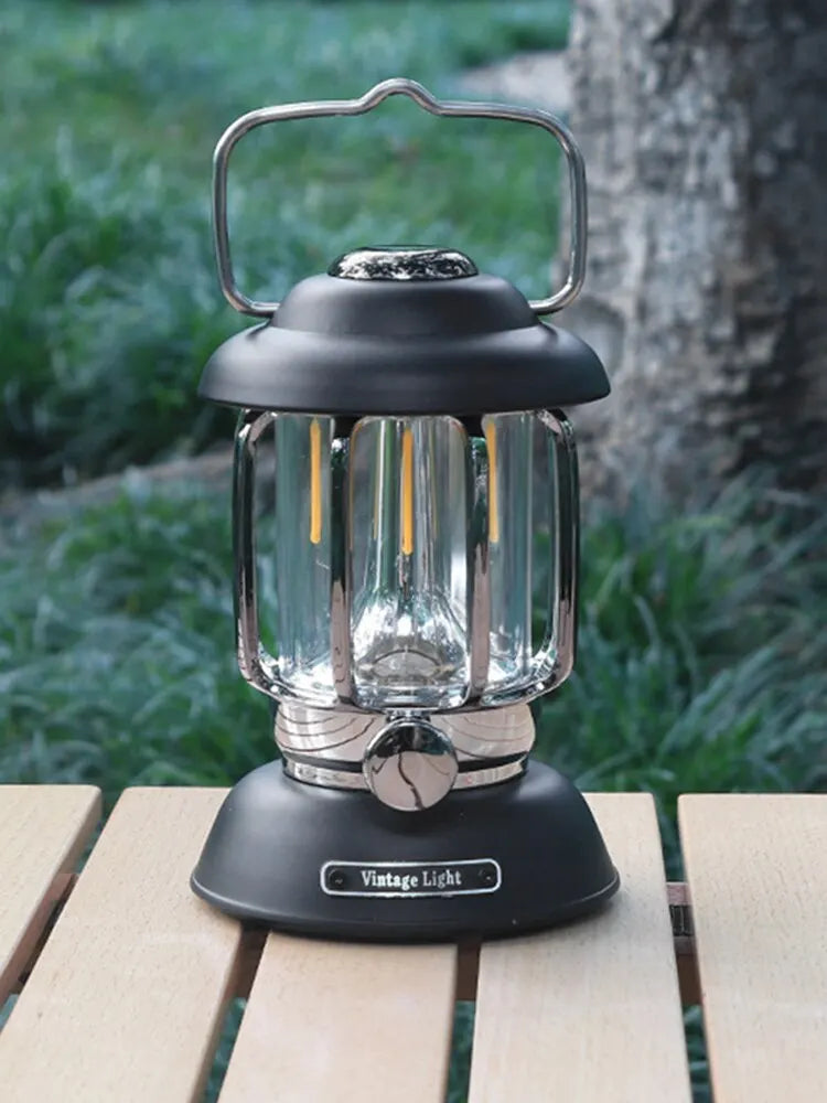 Black retro LED camping lantern on a wooden table